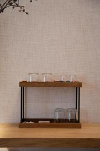 a shelf with glasses on top of it at Agorà Luxury Experience in Zafferana Etnea +27 photos