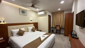 a hotel room with a bed and a television at Hotel La Hotera in Hyderabad