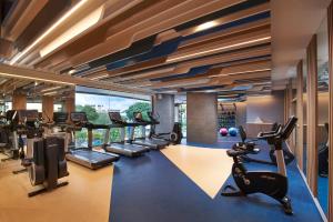 a gym with treadmills and elliptical machines at OZO North Pattaya in Pattaya