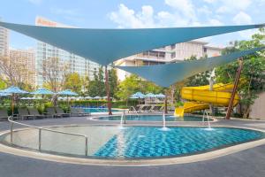 a pool with a slide and a water park at OZO North Pattaya in Pattaya