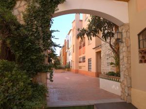 an archway in an alley between two buildings at Apartment Empuriabrava by Beach & Canals in Empuriabrava +24 photos