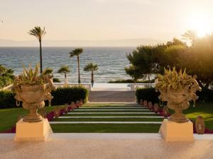 a stairway leading to a resort with the ocean at Mandola Rosa, A Resort to Live in Loutra Killinis