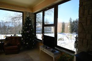 a living room with a christmas tree and a television at Ca' Tra Cielo e Monti in Frassinoro