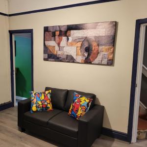 a couch in a living room with a painting on the wall at Ince House in Liverpool
