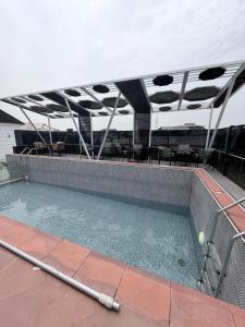 a swimming pool with a tennis ball in it at Emiez Apartment and Hotel in Benin City