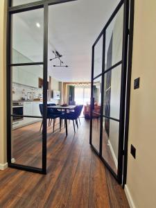 a living room with glass doors and a dining room at By The Pool Apartments #7 in Velingrad