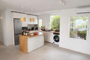 a kitchen with white walls and a large window at AriaSpot Alicante in Gran Alacant