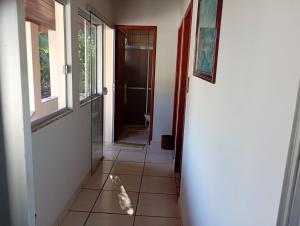 a hallway with a door and a cat walking into a bathroom at Casa 4 Quartos garagem 3 carros, churrasqueira e ar condicionado, in São José +32 photos