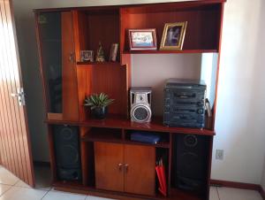 a book shelf with a speaker and a radio at Casa 4 Quartos garagem 3 carros, churrasqueira e ar condicionado, in São José