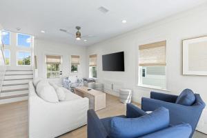 a living room with two couches and a tv at 26 Blue Coast Ct in Inlet Beach