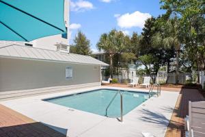 a swimming pool in a yard with a house at 26 Blue Coast Ct in Inlet Beach