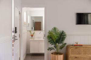 a bathroom with a sink and a potted plant at Sunrise Guesthouse in Byron Bay +44 photos