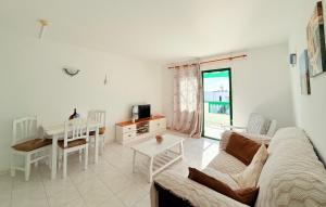 a living room with a couch and a table at -MONTORIAN View LANZAROTE- in Puerto del Carmen