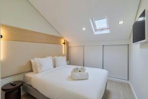 a bedroom with a bed with two towels on it at Setúbal Serenity Villa I, By Home Match in Setúbal