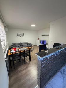 a living room with a table and a couch at Apartman AURORA Trstenik in Trstenik