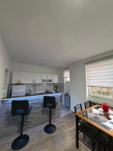 a kitchen with a table and chairs and a dining room at Apartman AURORA Trstenik in Trstenik +11 photos