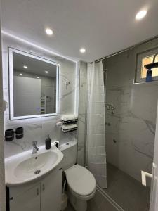 a bathroom with a sink and a toilet and a mirror at Apartman AURORA Trstenik in Trstenik