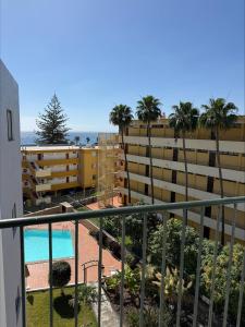 a view of the pool from the balcony of a apartment at Los Ficus in Playa del Ingles