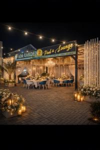 a restaurant with tables and chairs at night with lights at Pensiunea Ada in Balta Verde
