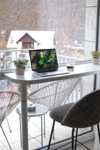 a laptop computer sitting on a table on a balcony at AVA Studio Sinaia in Sinaia