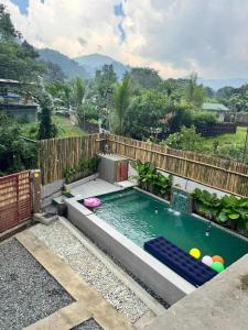 a swimming pool with balls in the water at Tony nature place in Antipolo