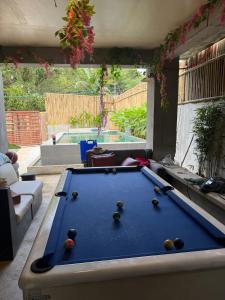 a pool table in the middle of a living room at Tony nature place in Antipolo