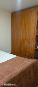 a bedroom with a bed and wooden cabinets at Savannah milestone in Gilgil