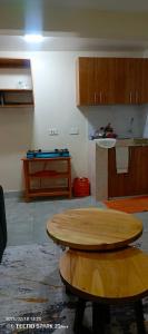a living room with a table and a kitchen at Savannah milestone in Gilgil