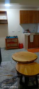 a kitchen with two wooden tables in a room at Savannah milestone in Gilgil +6 photos