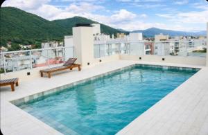 a swimming pool on the roof of a building at Alcazar Suites Premium in Salta