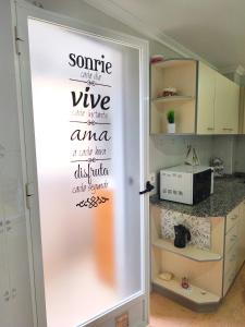 a sliding door with words on it in a kitchen at Estudio Petrer in Petrer +4 photos