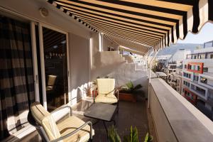 a balcony with chairs and tables on a building at Best Western Plus Embassy Hotel in Athens