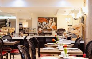 a dining room with tables and chairs in a restaurant at Best Western Plus Embassy Hotel in Athens