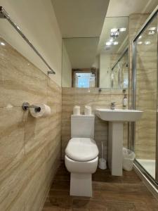 a bathroom with a toilet and a sink at The Paramount Hotel in London +135 photos