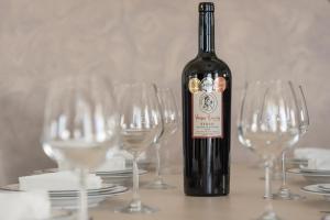 a bottle of wine sitting on a table with wine glasses at Villa Nina with Private Pool in Kolymvari