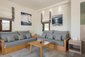 a living room with two couches and a table at Villa Nina with Private Pool in Kolymvari +27 photos