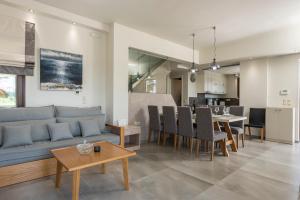a living room with a couch and a table at Villa Nina with Private Pool in Kolymvari