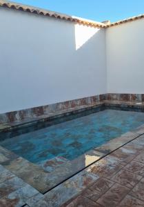 a swimming pool with blue water in a room at En Ca La Abuela Casa Rural in Consuegra