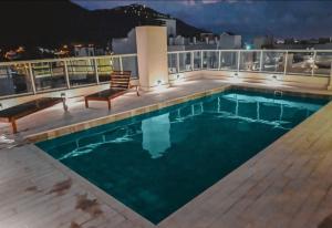 a swimming pool on the roof of a building at Alcazar Suites Premium in Salta