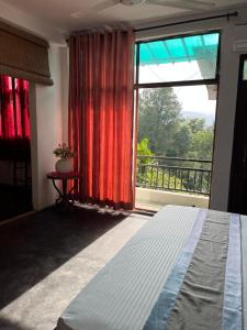 a bedroom with a bed and a large window at Rock House Villa in Kandy +4 photos