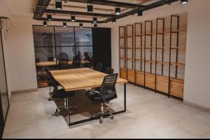 a conference room with a wooden table and chairs at Alcazar Suites Premium in Salta
