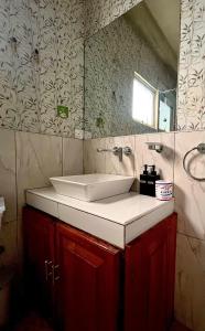a bathroom with a sink and a mirror at Medalin Lake Gregory in Nuwara Eliya +43 photos