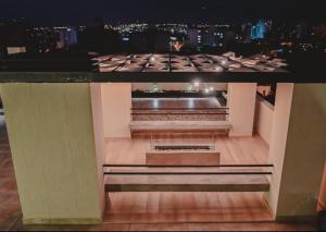 a view of a building at night with a bench at Alcazar Suites Premium in Salta