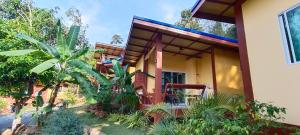a house with a lot of plants in front of it at Alisa Bungalows in Ko Chang
