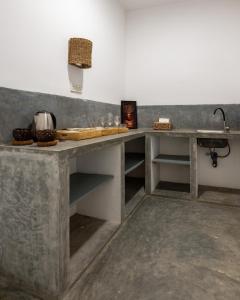 a kitchen with a concrete counter and a sink at La Cove in Matara +35 photos