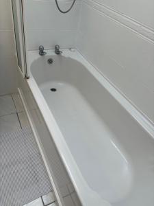 a white bath tub in a bathroom at Riverchapel Guesthouse in Courtown +29 photos