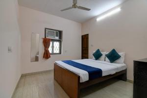 a bedroom with a bed and a ceiling fan at Hotel Soft Petal BB Block in Kolkata