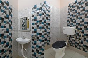a bathroom with a toilet and a sink at Hotel Soft Petal BB Block in Kolkata