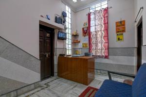 a waiting room with a door and blue chairs at Hotel Soft Petal BB Block in Kolkata
