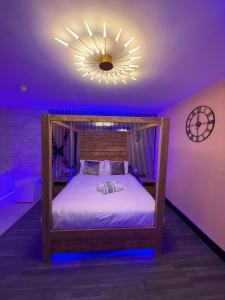 a bedroom with a bed with a clock on the wall at Luxury Jacuzzi Suites Halifax in Halifax +31 photos